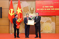 N.A. official honored with 30-year Party membership badge